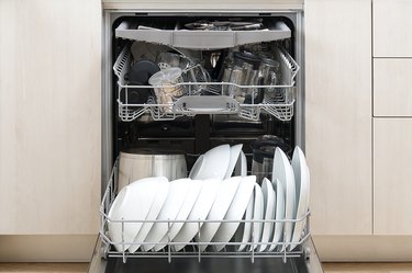 large dishes loaded along side of dishwasher