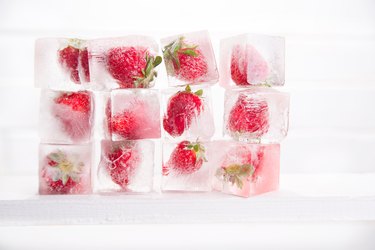 Close-Up Of Ice Strawberries Against White Background