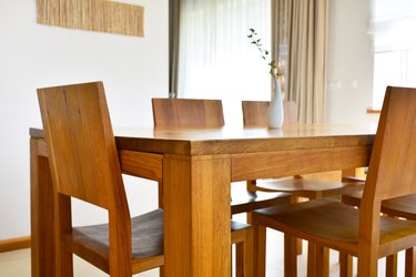 Natural oak wood dining table and chairs in modern interior design house