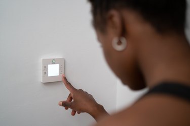 young black woman using home automation at home