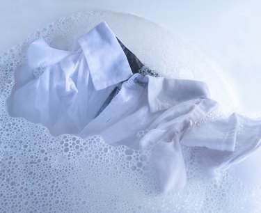 White shirt soaking in water with detergent.