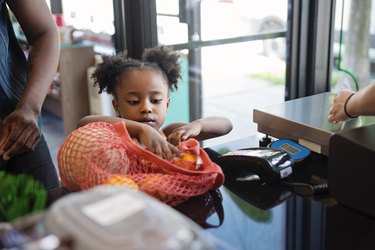 Customers shopping in small zero waste oriented fruit and grocery store.