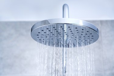 Rain shower. Water supply concept. Water pouring from a showerhead.