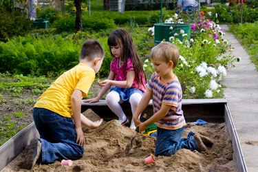 Kids playing in sandbox.