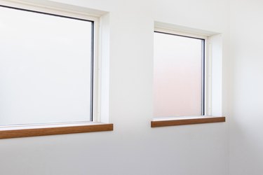 Two square frosted glass windows on the white wall