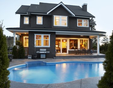 Canada, British Columbia, Surrey, back yard of house with pool at dusk