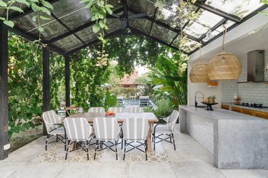 outdoor kitchen with glass roof and concrete countertops