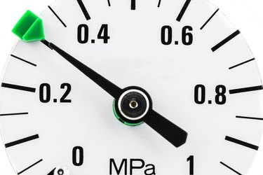 A macro photo of a pressure gauge scale to 1 Mpa showing a pressure of 0.3 Mpa, isolated on a white background.