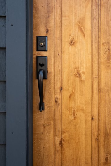 Oil rubbed bronze front door handle and deadbolt set, on a maple stained solid wood door