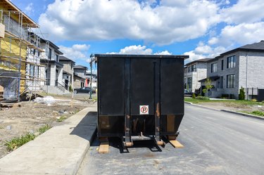 Loaded dumpster near a construction site