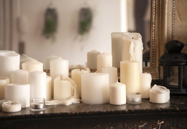 Large group of candles on fireplace