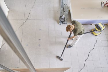 Vacuuming floor at construction site.