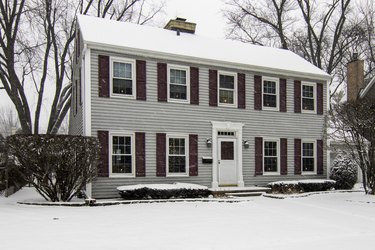 Saltbox Colonial House in Snowstorm
