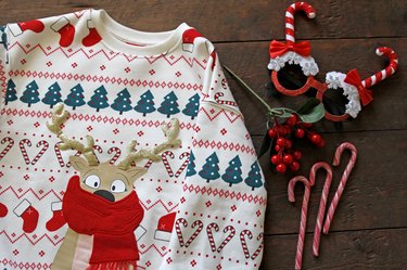 Christmas Sweater And Details On Wooden Background