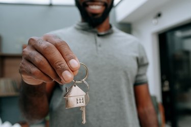 Man holding keys to new house
