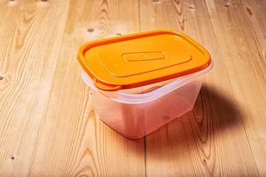 Plastic food container on a wooden table
