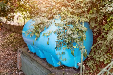 Blue water tank in a garden