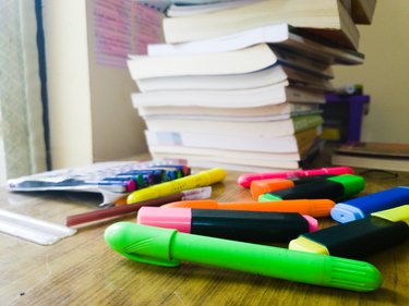 Table with highlighters and books.