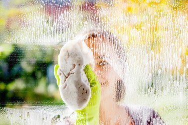 Woman cleaning window.