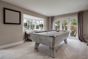 Pool table and sofa in luxury home.