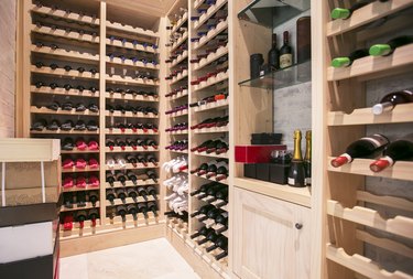 Wine bottles organized on racks in wine cellar