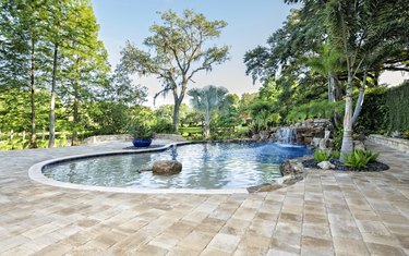 Beautifully Landscaped Swimming Pool with Waterfall at Estate Home