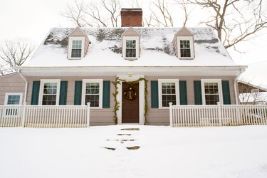 Snow covered Dutch colonial style home