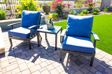 Backyard Patio With Two Arm Chairs With Cushions & Table With Centerpiece