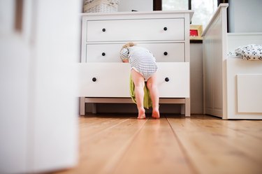 Toddler boy in a dangerous situation at home.