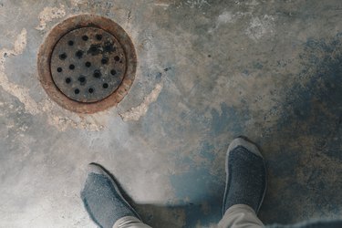 Rusted drain cover in basement.