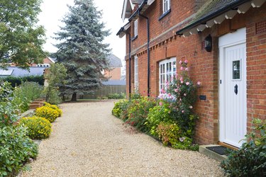 English country house, garden, and gravel driveway.