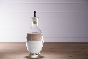 white vinegar on the wooden table