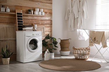 Stylish room interior with washing machine. Design idea.