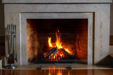 Burning fireplace. Fireplace as a piece of furniture. Christmas New Year concept decoration.