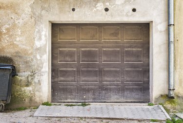 Garage wooden door, dirty cracked wall background