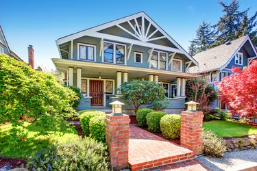 Large luxury blue craftsman classic American house exterior.