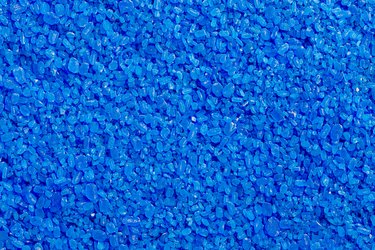 full frame background and texture of blue copper sulfate granules - close-up