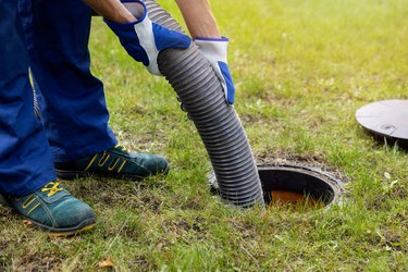 Pumping out household septic tank. Drain and sewage cleaning service.