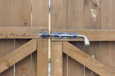 Sliding wooden gates for entry and exit are closed with a powerful steel bolt