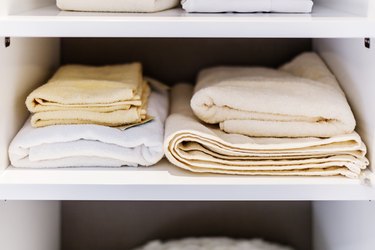 TOWEL CLOTH FOLD IN STACK IN WARDROBE SHELF INTERIOR CONCEPT