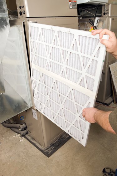Male Hands Change Large Pleated Furnace Air Filter