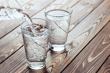 water pouring from jug into glass