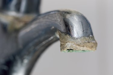 Close-up of limescale build-up. Selective focus on hard water deposit.