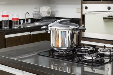 Household appliances - pressure cooker in a kitchen setting.