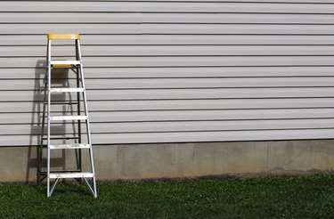 A step ladder against a side of a residential home