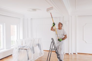 Man painting a ceiling.