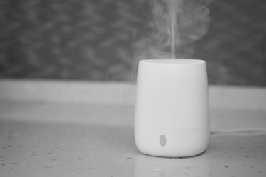 Air humidifier stands on tabletop surface