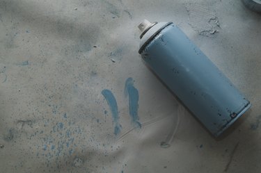 Used spray paint can on dirty background