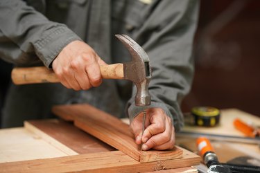 Carpenters uses a hammer to driving nail