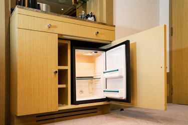 a refrigerator under the bar counter, according to the appearance of the refrigerator, it is a small size that is found only at the hotel, and can only hold a limited amount of stuff.